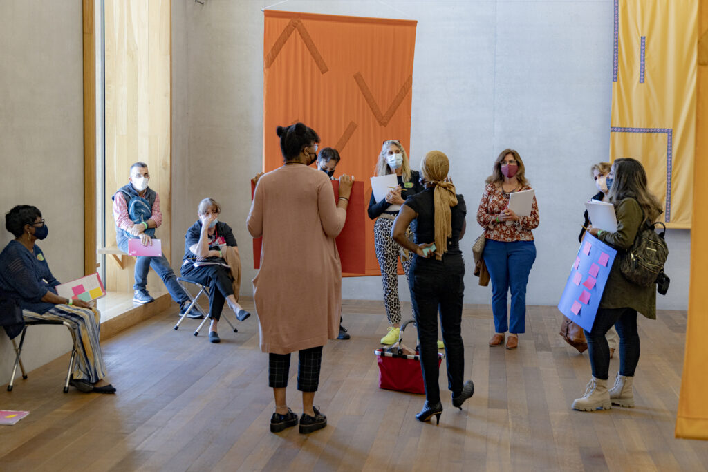 A group of educators and museum staff having a conversation in a gallery.