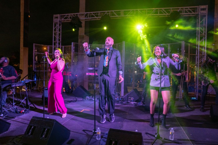 Three performers on stage