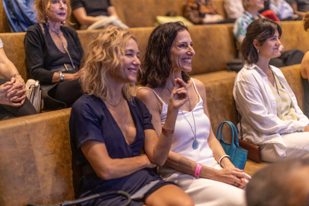Visitors smiling in the auditorium