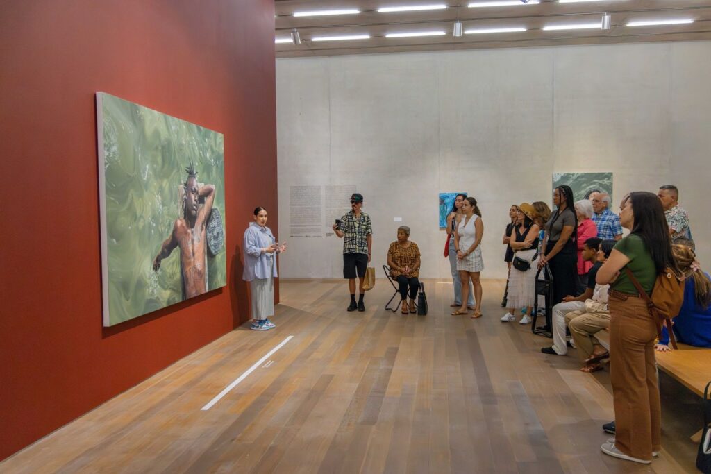 Art curator leading a tour in a gallery.