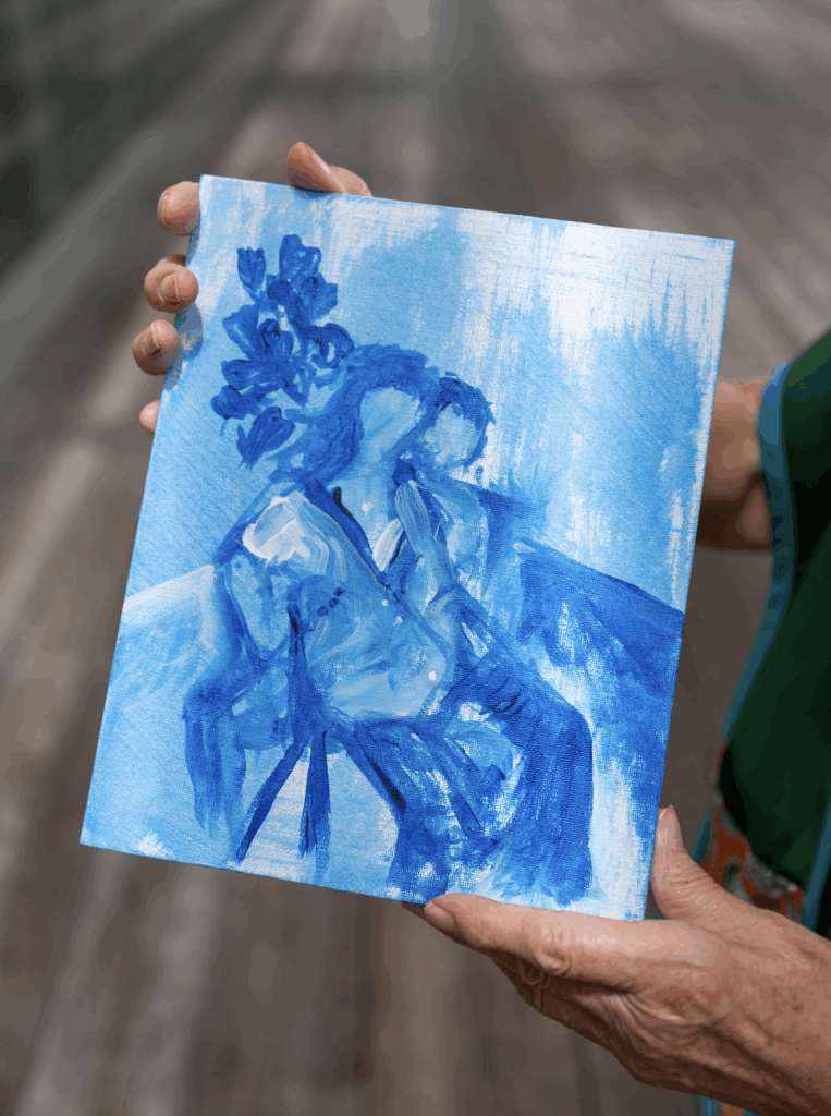 Blue watercolor painting of two people sitting  